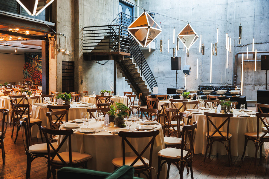 Warm white event lighting with elegant mirror chandeliers at Fremont Foundry in Seattle creating a refined industrial atmosphere.