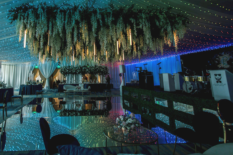 Multicolored twinkle lighting under event draping with a mirror dance floor at Four Seasons Seattle.